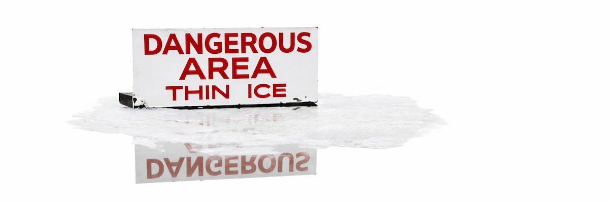 تابلوی هشدار منطقه خطرناک و یخ نازک در محیط قطبی؛ نماد عبور از مرز سلامت روان در تخیلات.